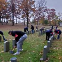 Volunteers cleaning the tombstones